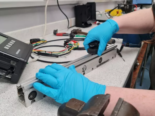 Expert technician performing encoder repairs at Encoders UK